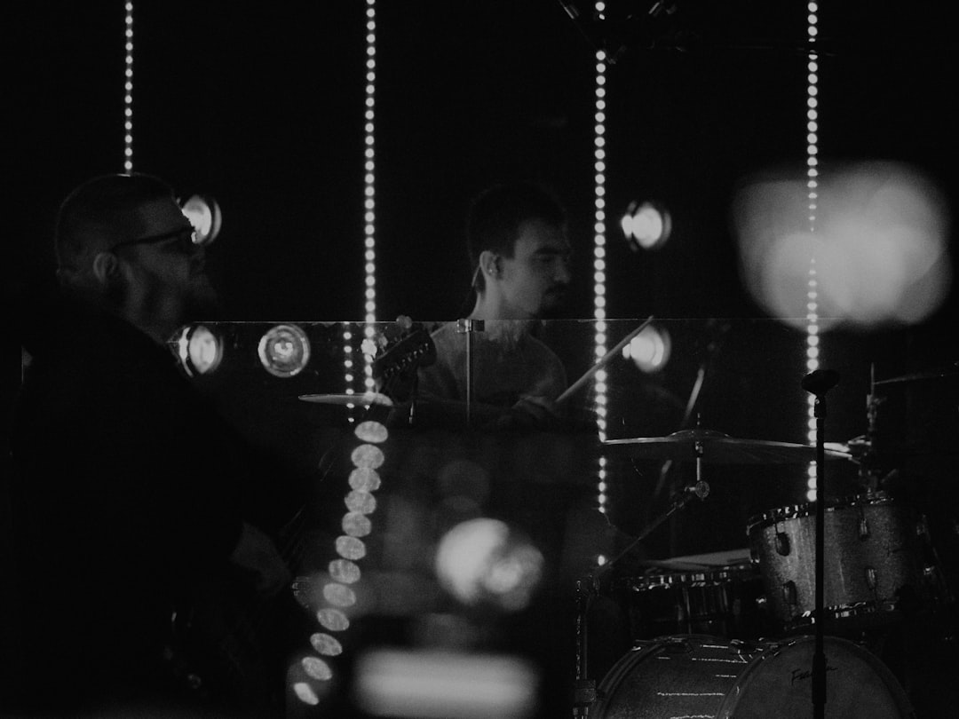 two men playing instruments in a dark room
