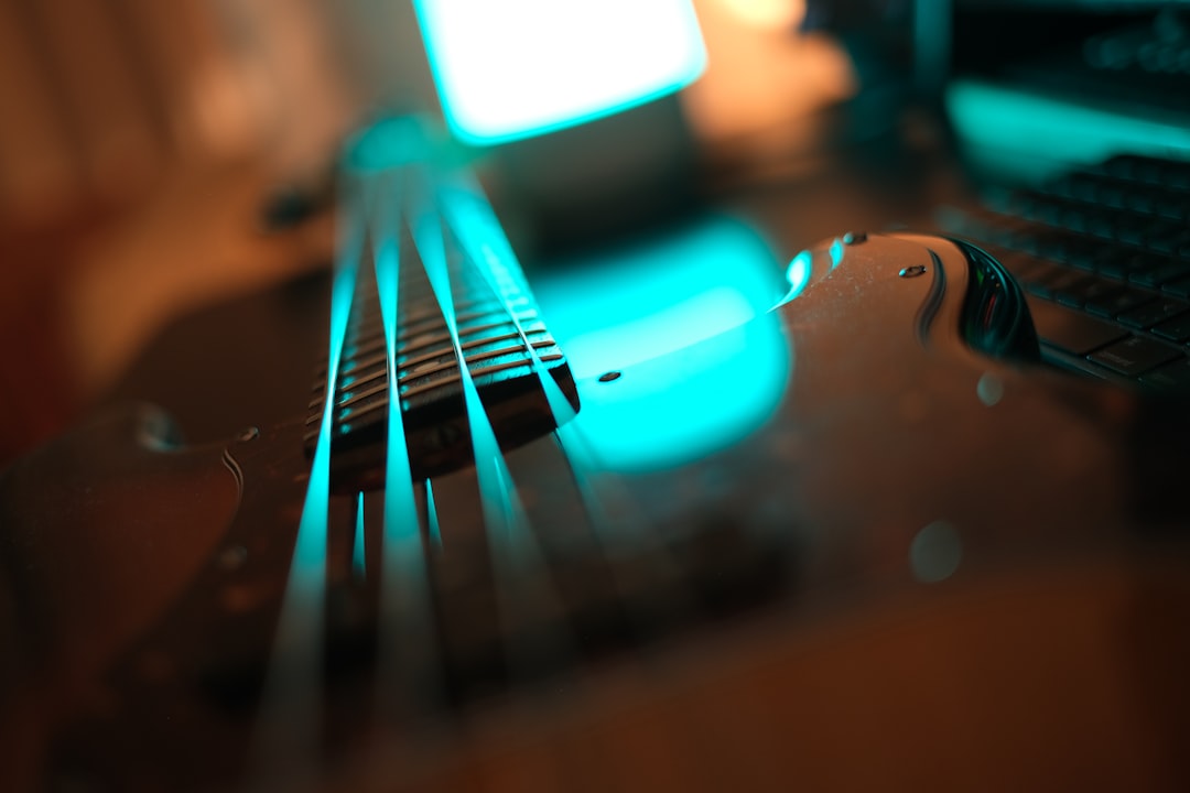 A bass guitar reflected in blue light.